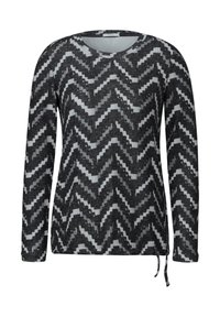 Långärmad pullover i svart och grått med ett chevronmönster. Tillverkad av mjukt tyg med rundad halsringning och sidodragkedjor för justering.