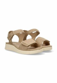 Sandalias beige con tiras cruzadas y cierre de gancho y bucle, que cuentan con una plantilla acolchada y una textura suave. Suela plana y ligera.