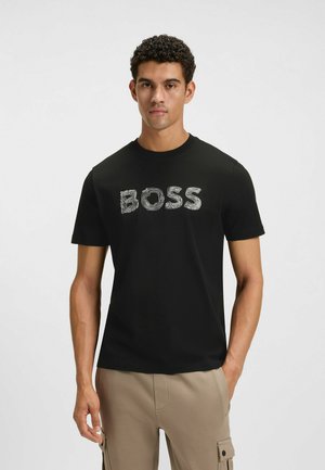 Black cotton t-shirt with short sleeves featuring textured "BOSS" logo in light gray. Crew neck design with a smooth fabric finish.