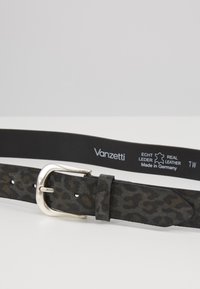 Black leather belt featuring a leopard print texture. Silver metal buckle with a smooth finish. Label reads "Vanzetti," made in Germany.