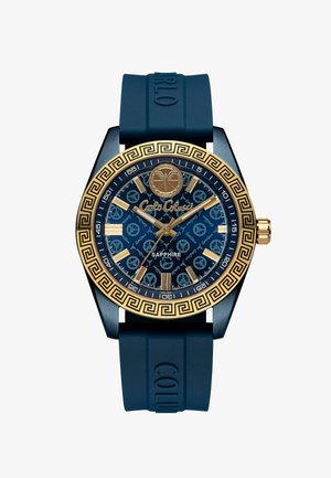 Orologio con cinturino in silicone blu, con una lunetta placcata in oro, vetro zaffiro e un quadrante blu decorato con accenti dorati e indicatori delle ore.