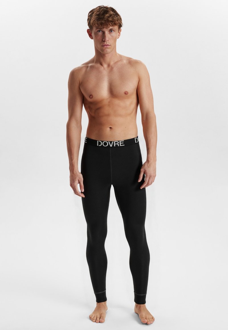 Sorte termolegning med en tætsiddende design og elastisk talje, der har teksten "DOVRE" i hvid. Blødt, strækbart stof.