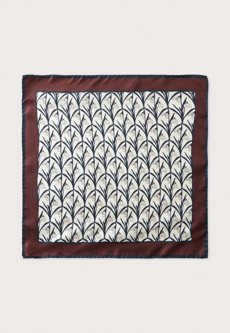 Foulard en soie avec bordure rouge foncé, centre crème présentant un motif répétitif de tige florale noire et fleur en forme de cloche blanche.