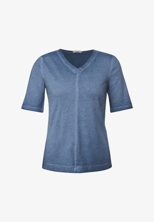 Sininen lyhythihainen V-pääntie T-paita, joka on valmistettu pehmeästä kankaasta, jossa on silkkinen rakenne. Paitassa on keskisauma ja huomaamattomia ompeluyksityiskohtia.