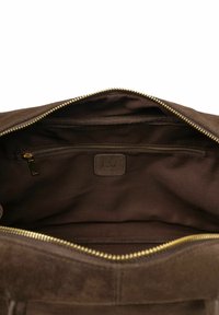 Brown suede bag interior with gold zipper, featuring a zippered pocket and a leather label embossed with "L37." Soft texture and spacious design.