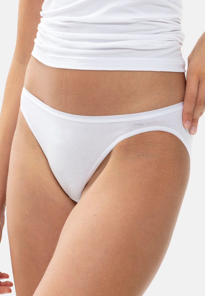 Slips bianchi in cotone con design a vita bassa. Texture liscia, cintura elastica minimale e logo del marchio stampato sul lato.