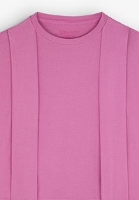 Pink cotton t-shirt with a round neck, featuring a plain design and subtle pleating detail on one side. Soft texture, no visible graphics.