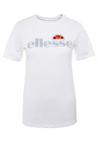 Hvid bomulds T-shirt med et gråt "ellesse" logo og et farverigt solgrafik i rød og orange på den øverste venstre side. Korte ærmer.