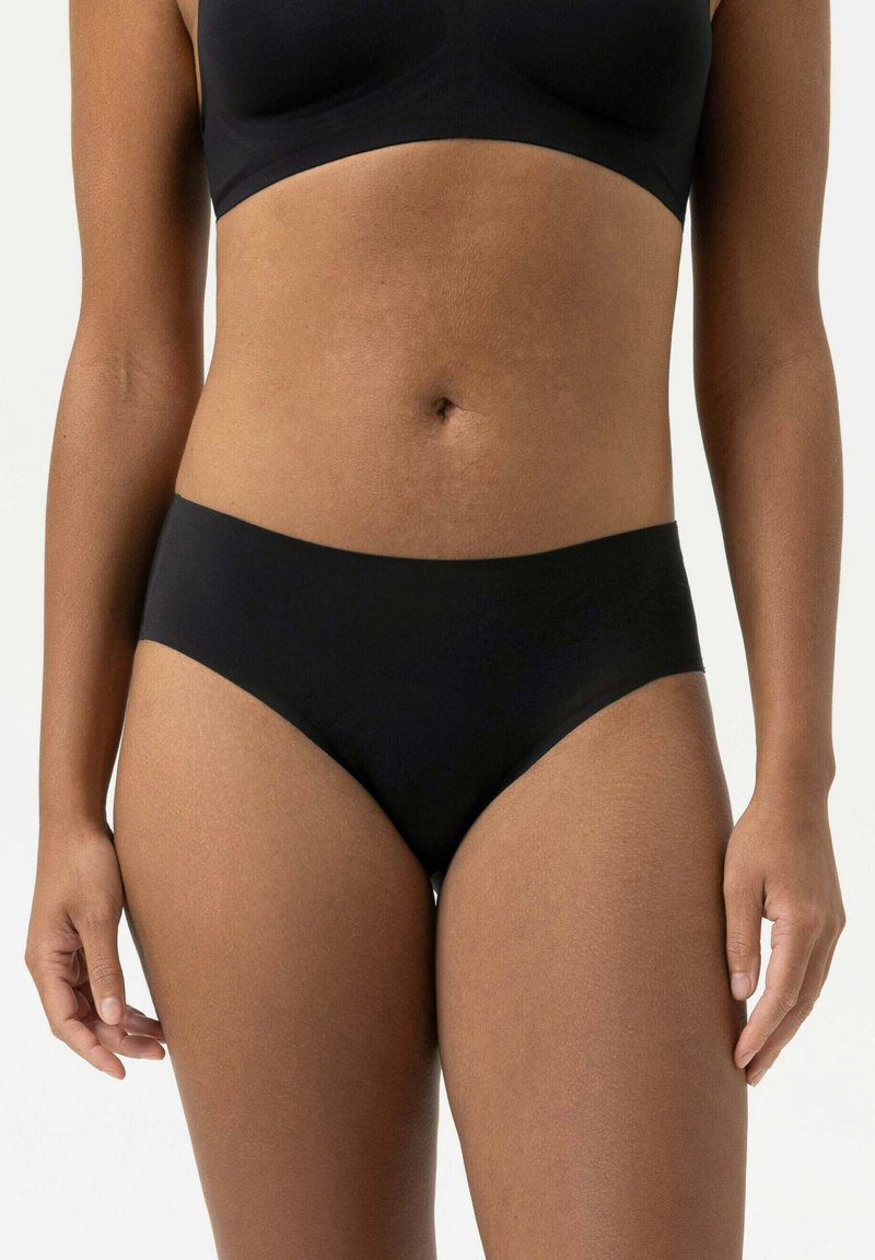 Mutande nere a vita alta realizzate in materiale liscio. Presentano un design senza cuciture con un elastico morbido e un taglio classico.