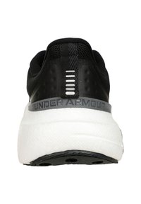 Black athletic shoe with a textured upper, white midsole, and grey accent band featuring "UNDER ARMOUR" text. Heel shows design details.