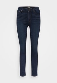 Jeans ajustados de color azul oscuro con una textura suave, diseño de cinco bolsillos y costuras de contraste sutil a lo largo de las costuras.