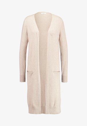 Šviesiai ruda ilga kardiganas, pagamintas iš minkšto mezgimo audinio, turi atvirą priekį, dvi priekinės kišenes ir banguotas rankogalius bei apatinę dalį.