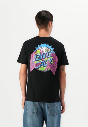 Black cotton t-shirt featuring a colorful graphic on the back, depicting a globe with stylized hands and the text "Santa Cruz" in vibrant colors.