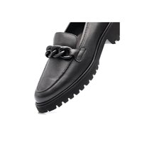 Black leather loafer with chunky rubber sole and large black chain detail across the top, angled to show side and front view.