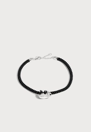 Bracelet en cordelette torsadée noire avec un charm panda argenté et noir et un fermoir chaîne argenté ajustable.