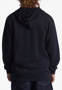 Navy blue hoodie featuring a large hood, ribbed cuffs, and hem. Made of soft fabric with a smooth texture, showing a simple design.