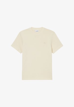 T-shirt en maille crème à manches courtes de Lacoste avec col rond et motif texturé subtil.