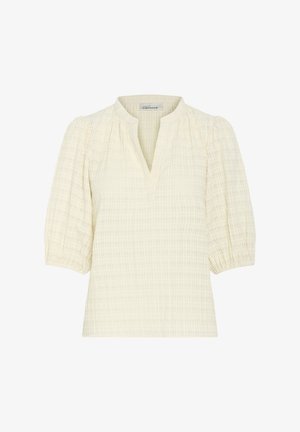 Kremowa bluzka z teksturowanym wzorem, krótkimi bufkami i dekoltem w kształcie V. Wykonana z lekkiego, oddychającego materiału.