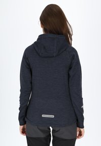 Navy blue hoodie with a textured blend fabric, featuring a drawstring hood and a logo patch at the lower back. Raglan sleeves and gray accents.