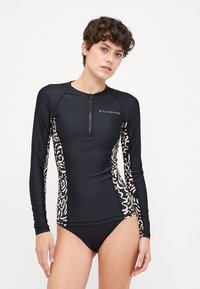 Long-sleeve black rash guard with a front zipper, featuring cream abstract patterns on the sides and a small logo on the chest.