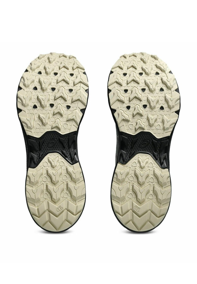 Suola nera e crema con un motivo di battistrada robusto e multidirezionale. Area del tallone rinforzata con gomma testurizzata per la massima durata.