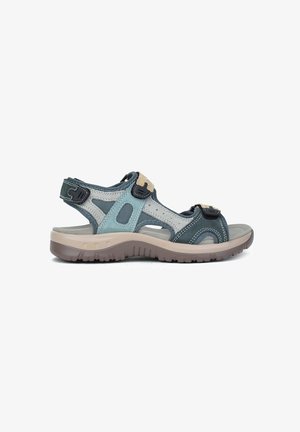 Sandalias cómodas con materiales sintéticos en teal oscuro, gris claro y beige. Cuentan con correas ajustables y una suela de goma texturizada para mayor agarre.
