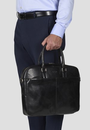 Black leather briefcase with dual top handles, smooth texture, rectangular shape, and silver-tone hardware. Featured front pocket for documents.