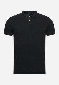 Polo shirt nera in cotone con finitura testurizzata. Caratterizzata da un colletto classico, una chiusura a due bottoni e un logo del marchio discreto sul petto.