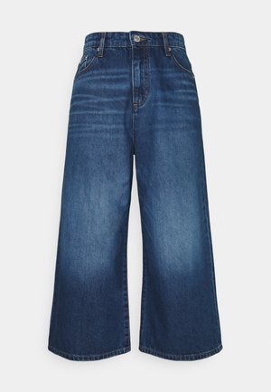 Donkere blauwe denim culottes met een vervaagde wassing. Kenmerkt zich door een hoge taille, wijde pijpen en een ontwerp met vijf zakken. Effen zoom, klassieke knoopsluiting.