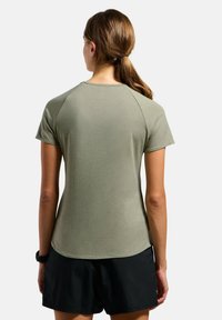 Olive green short-sleeve t-shirt with a round neckline and smooth texture, featuring raglan sleeves and a curved hem.