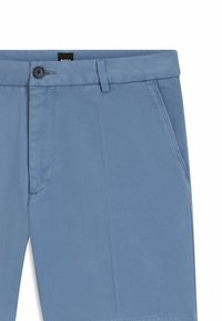 Light blue cotton trousers featuring a textured, herringbone pattern, a button closure, and side pockets for functionality.