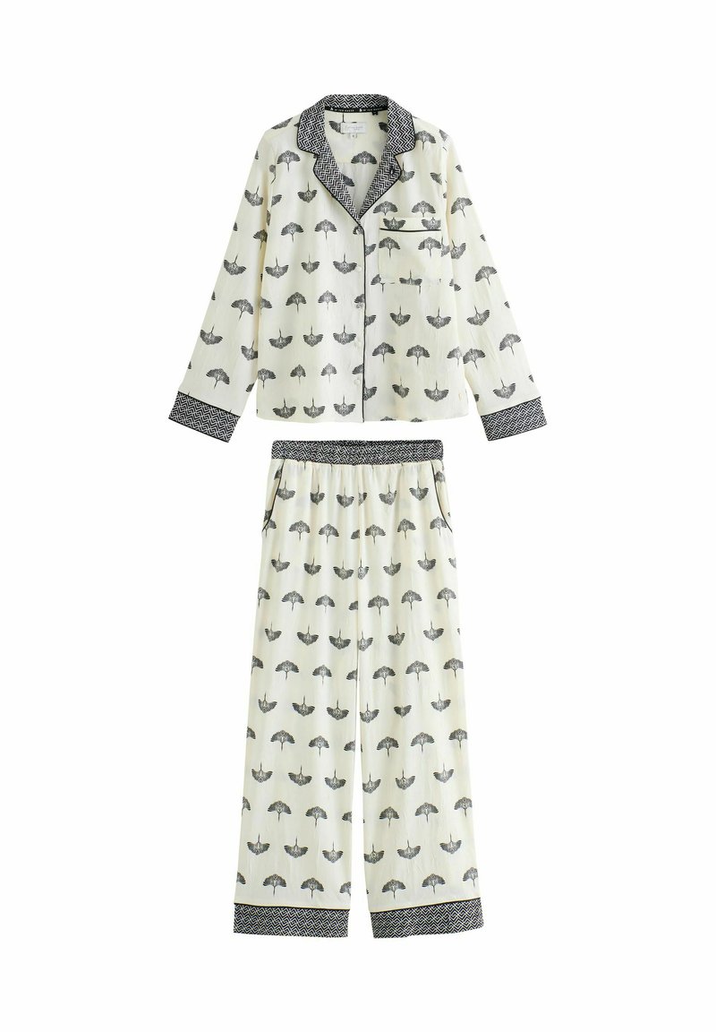 Weißes Schlafanzugset mit schwarzem Regenschirm-Muster, langärmelige, durchknöpfbare Oberteile mit Tasche und passenden, elastischen Hosen mit gemusterten Bündchen.