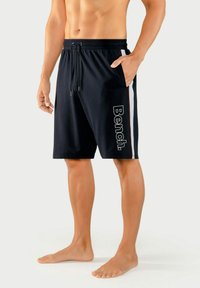 Black swim shorts with a drawstring waist, side pockets, and a white side stripe featuring "Bench." logo in large font on the left leg.