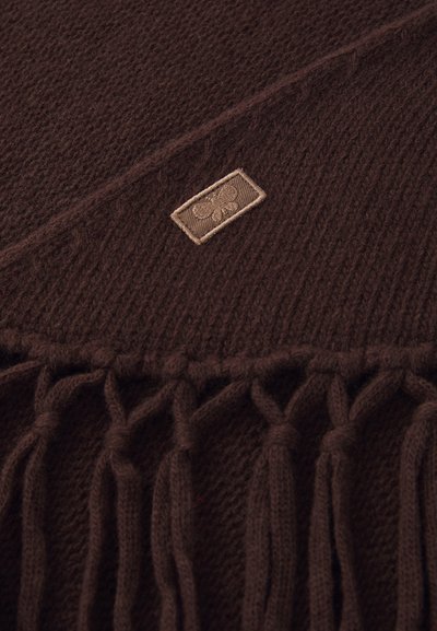 Brown knitted scarf featuring a textured pattern, fringe edges, and a small beige fabric label with an embossed design.