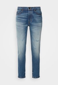 Jeans de denim de color azul claro con un corte ajustado, que presentan parches desgastados, áreas desvaídas y un diseño clásico de cinco bolsillos. Cierre con botón de metal.