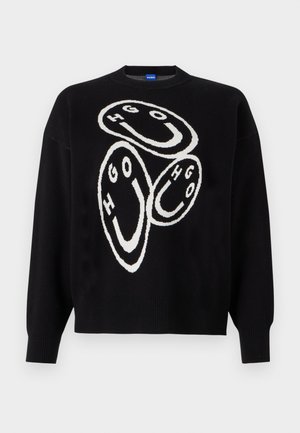 Black knitted sweater featuring white graphic design with circular shapes and the letters "HGO." Ribbed cuffs and hem accentuate the structure.