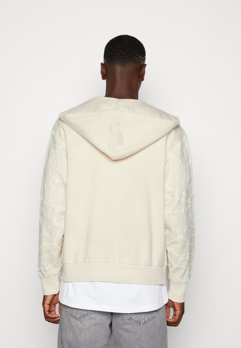 Jaded London SPIDER WEB ZIP HOODIE - Zip-up sweatshirt - ecru/beige -  Zalando.de