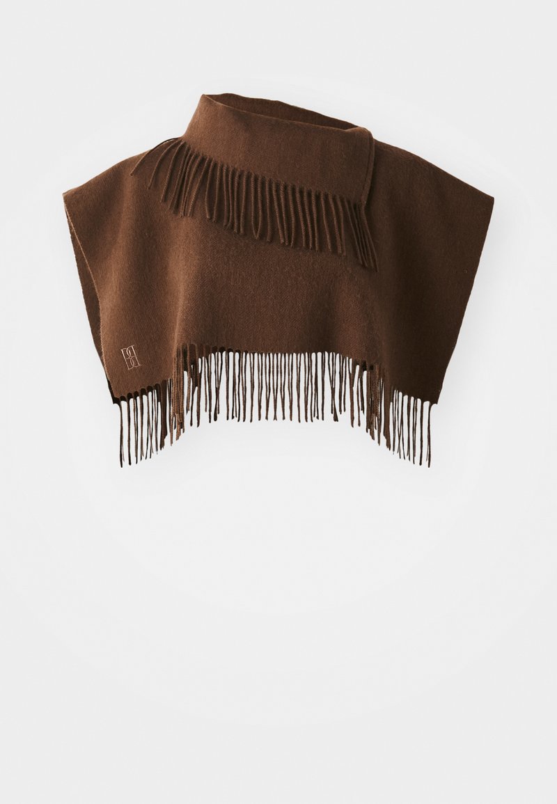 Brown wool poncho with high collar and fringe detailing along the bottom and collar edges on a white background.