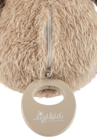 Plush toy with shaggy beige fur, featuring a visible zipper and a round beige plastic handle with "sigikid" logo.