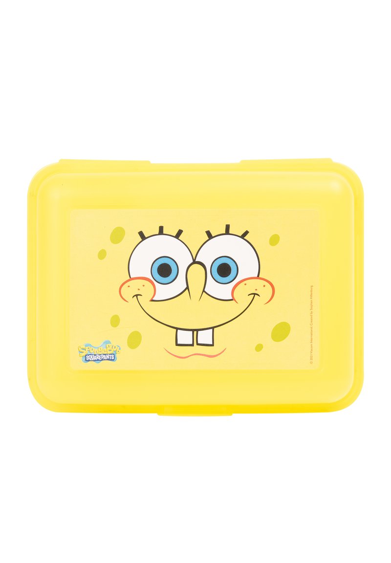 Yellow plastic lunch box featuring a cartoon character face with large blue eyes, a smiling mouth, and a textured background with small bubbles.