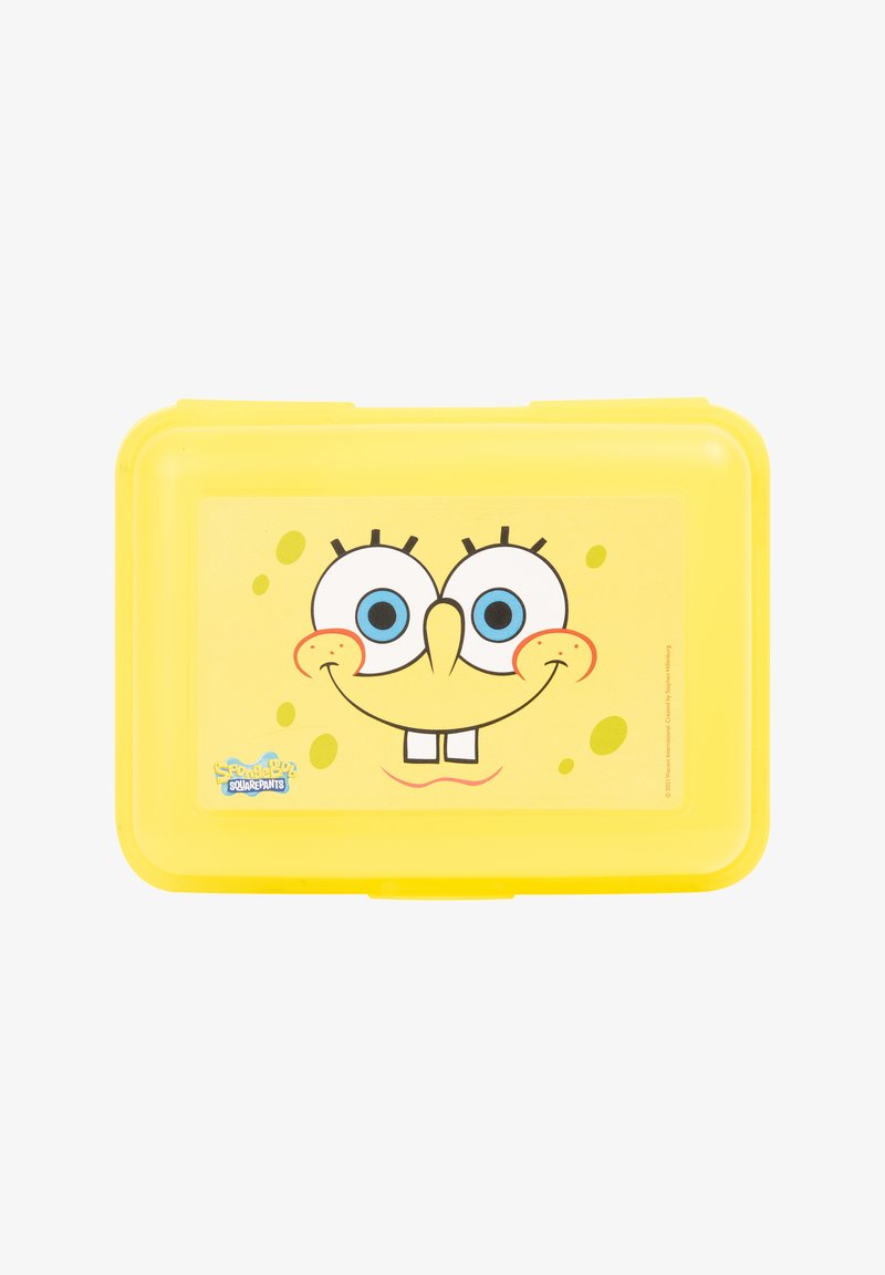 Yellow plastic lunch box featuring a cartoon character face with large blue eyes, a smiling mouth, and a textured background with small bubbles.