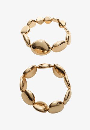 Bracciale in tono oro con maglie ovali e rotonde di varie dimensioni, caratterizzato da una superficie liscia e lucida e un design senza soluzione di continuità.