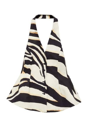 Top à encolure halter présentant un motif zèbre noir et crème, avec un design évasé et une fermeture à boutons sur le devant. Le tissu a une texture douce.