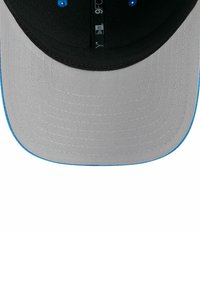 Gray cap with a black visor, featuring a blue accent along the edge and blue ventilation eyelets. Flat bill design and textured surface.