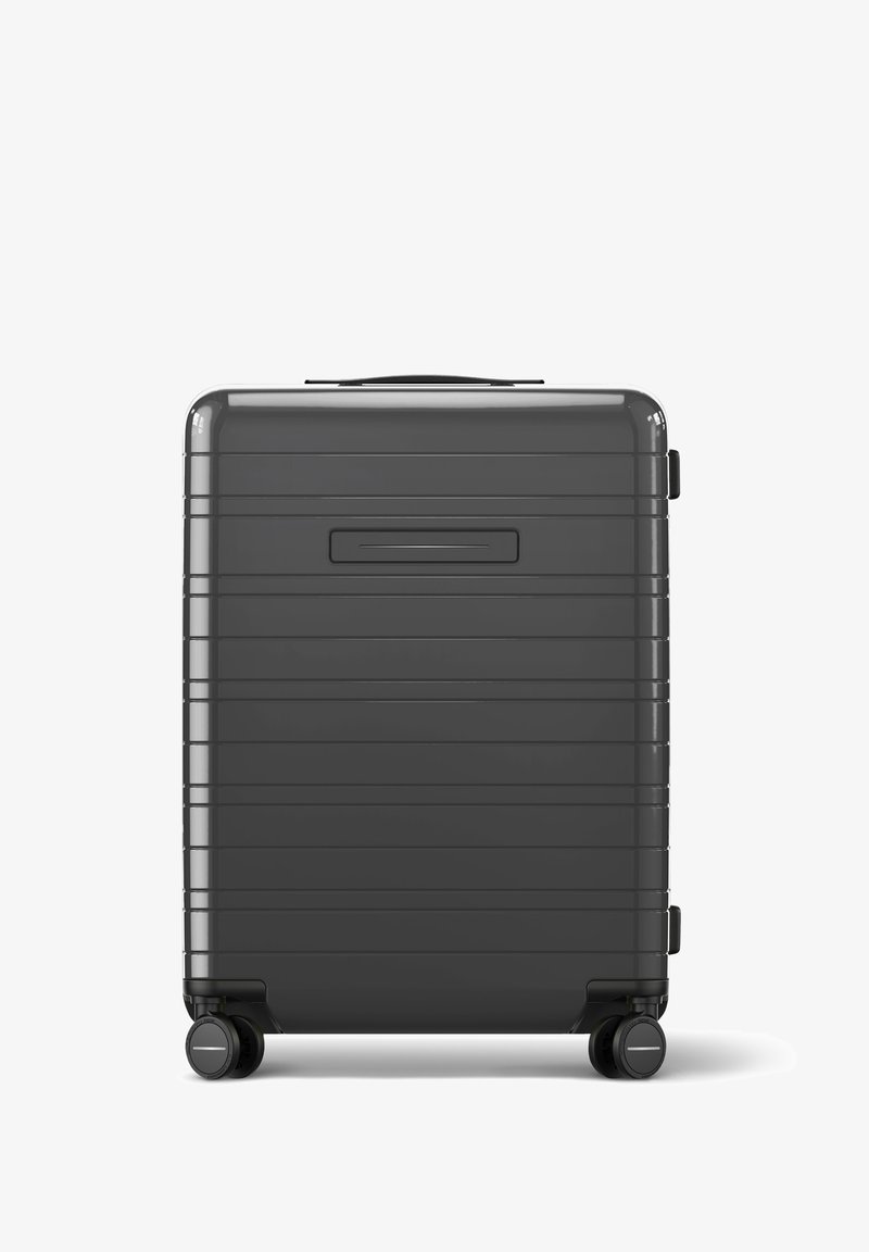 Hartschalentrolley in Dunkelgrau, mit einem geriffelten Design, einem Oberhandgriff, einem Seitenhandgriff und vier schwarzen Spinner-Rädern für Mobilität.