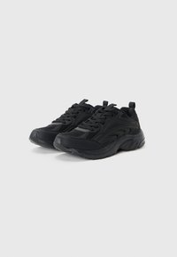 Black athletic shoes featuring a textured mesh upper, padded collar, lace-up design, and a thick rubber sole with grip patterns.