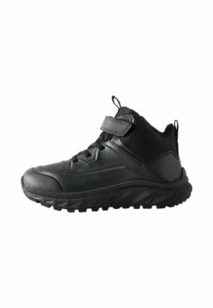 Black athletic shoes with a high-top design, synthetic material, textured accents, and a rugged sole featuring prominent treads for traction.