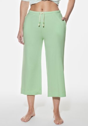 Helle grüne, hochgeschnittene, weit geschnittene Hosen mit elastischem Bund und Kordelzug. Verfügt über Taschen an jeder Seite und hat eine weiche Baumwolltextur.