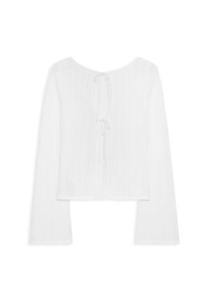 Weißes Langarmshirt mit strukturiertem Muster, cropped Design und einer Bindeschließe im Rücken. Weicher Stoff mit bequemer Passform.