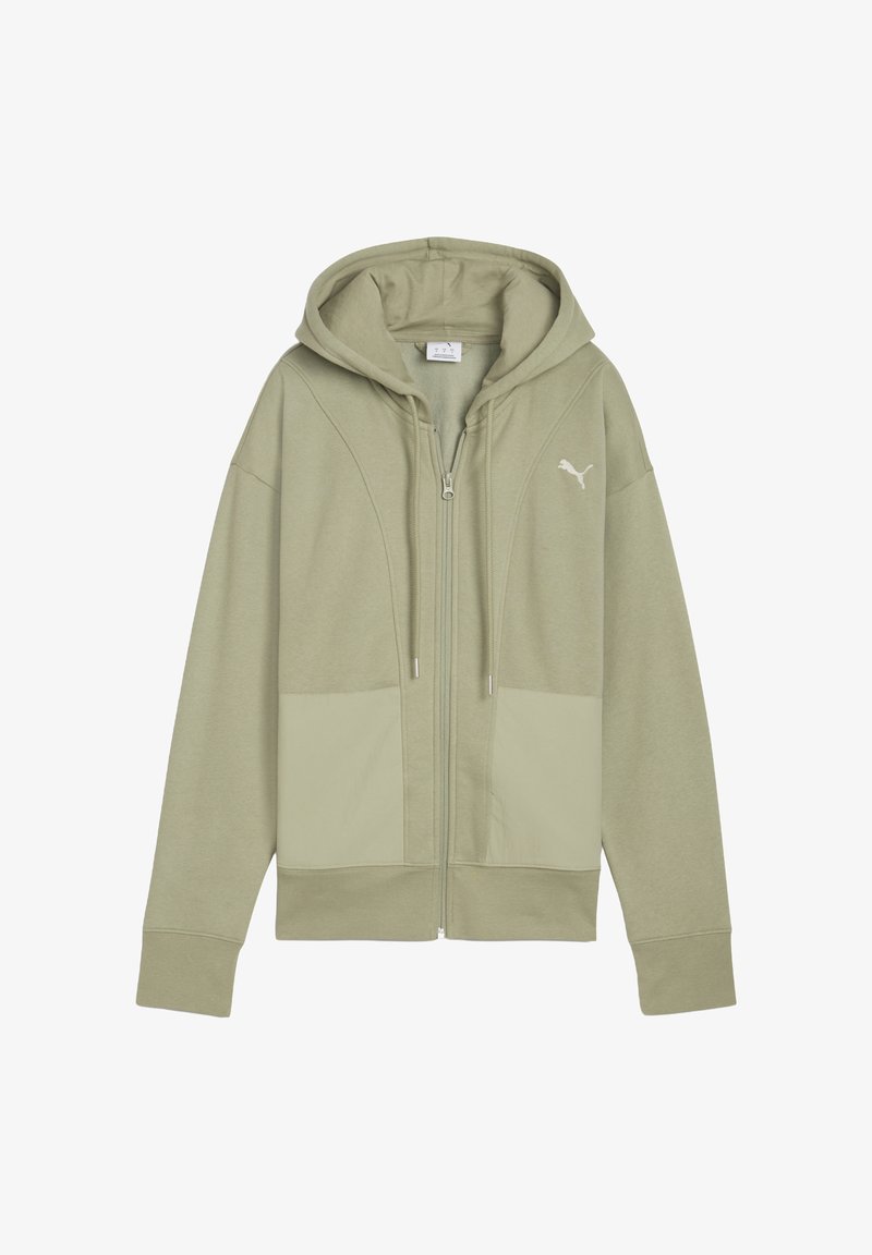 Hoodie zippé vert olive avec une capuche doublée, coupe oversized, tissu texturé et deux poches avant. Présente un logo blanc sur la poitrine.